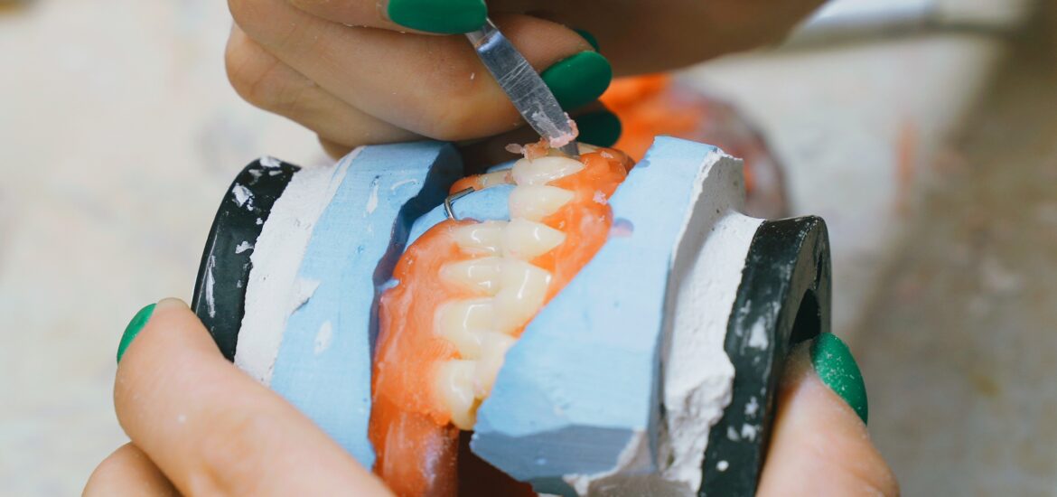 a pair of dentures being customized in Arlington