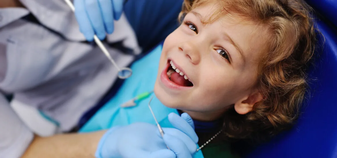smiling child in a dental chair